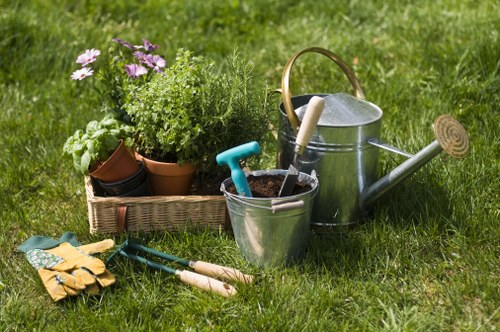 Gardener working on a Yiewsley garden entrance with tools and gloves